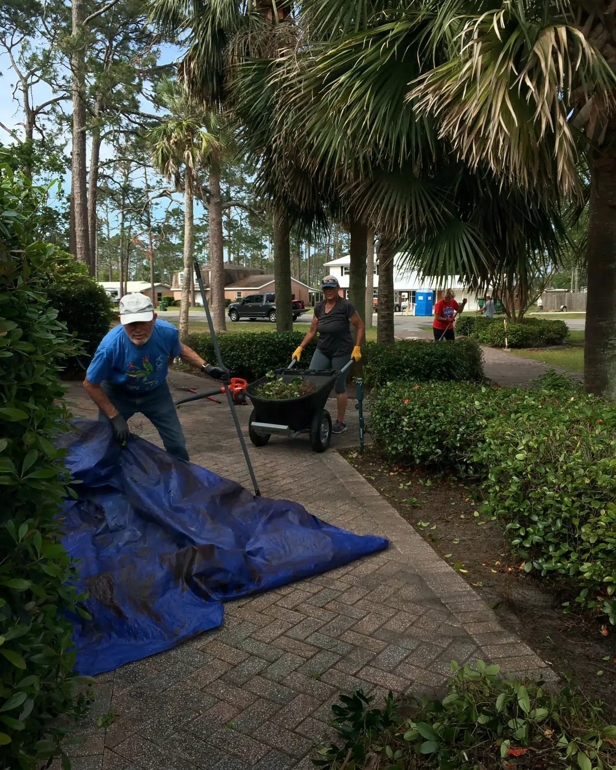 Volunteer workers cleaning up the yard